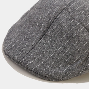 Detail shot of the dark grey wool blend fabric with pinstripes and neat stitching seams