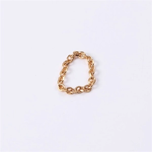 Macro shot of gold-plated stainless steel chain ring texture and interlocking links