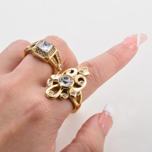 Elegant gold rings set with square and round white zircons on a model's hand