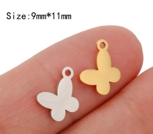 Detailed size comparison of 9x11mm butterfly charms in gold and silver finish on a finger