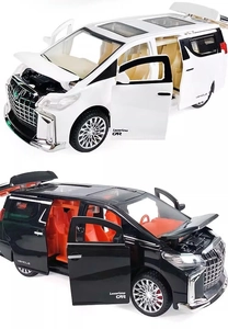 Macro view of black and white toy MPV models with open doors and detailed beige interiors