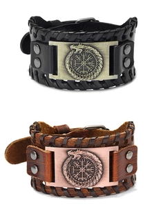 Detail of Viking compass and Ouroboros pattern on black and brown leather bracelets