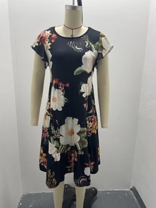 Detail view of floral print dress with layered tiered hem and ruffled sleeves