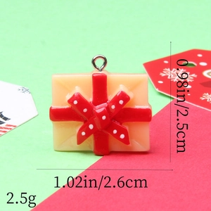 Detailed view of gift box resin pendant with red polka dot bow and size measurements