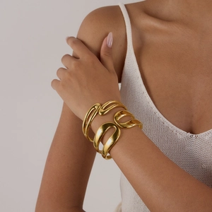 Close-up of minimalist 18K gold double-layered spring open bangle on a model