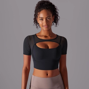 Close-up of black sports crop top featuring breathable mesh panels and chest cutout detail