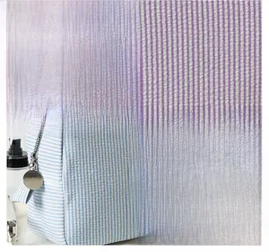 Detail of striped seersucker fabric and high-quality metal zipper on cosmetic bag