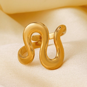 S-shaped irregular gold stainless steel open ring displayed on white silk fabric