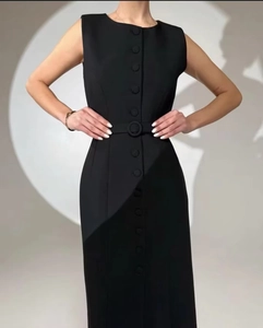 Close-up of sleeveless black button-down dress with a matching waist belt detail