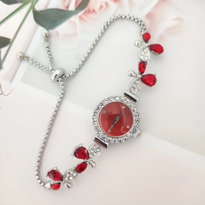Elegant floral silver watch with red teardrop crystals and sparkling rhinestones