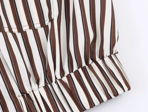 Macro view of vertical brown and black striped fabric with detailed stitching work