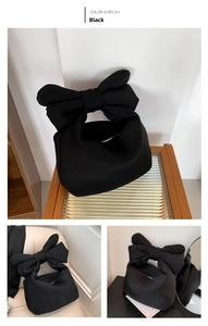 Detail view of a black puffer tote bag with oversized bow handle and secure zipper closure