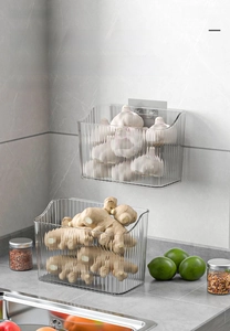Detail of wall-mounted ripple texture storage box for ginger and garlic organization