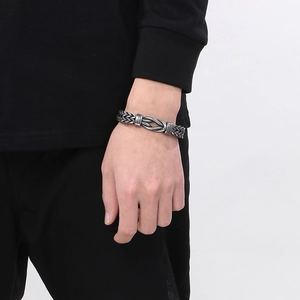 Macro detail of men's vintage silver braided wheat chain bracelet with ring clasp