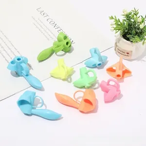 Close-up of colorful silicone pencil grips for kids with finger positioning rings