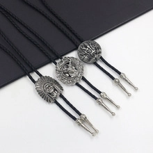 Close-up of three black braided leather bolo ties with vintage silver metal buckles