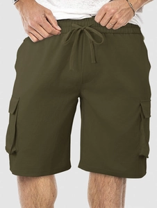 Detail view of olive green cargo shorts featuring elastic drawstring waist and large pockets