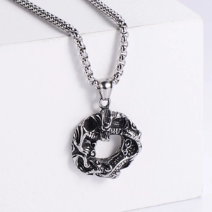 Macro shot of retro dragon ring necklace in titanium steel with vintage finish