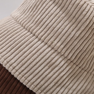 Close-up of corduroy texture showing beige and dark brown color block stitching details