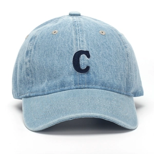Macro shot of navy letter C embroidery on light blue washed denim baseball cap