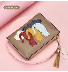 Detail of coffee brown PU leather wallet featuring five colorful cartoon cat appliques