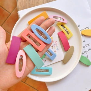 Close-up of matte candy-colored snap hair clips in oval and rectangular shapes for girls