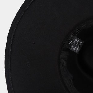 Detail of internal sweatband and 100% polyester material label inside the black felt hat