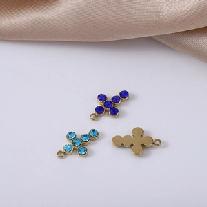 Detail of gold-plated stainless steel cross pendants with blue rhinestones for DIY jewelry