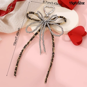 Detailed view of leopard print bow keychain with silver beads and dimensions shown