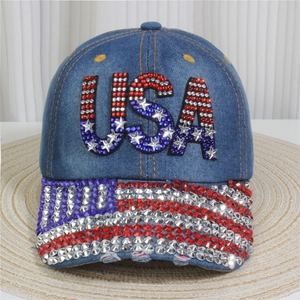 Detail of blue denim baseball cap with sparkling rhinestones and USA letter embroidery