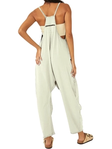 Back view of beige loose strap jumpsuit featuring thin straps and rear zipper pocket detail