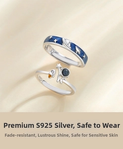 Detailed shot of S925 silver astronaut couple rings with blue starry sky enamel