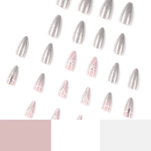 Almond press-on nails with silver glitter, geometric lines, and rhinestones design