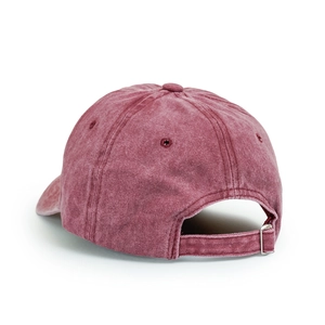 Macro detail of the adjustable metal buckle and vintage washed cotton texture on a red cap