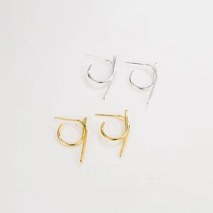 Macro detail of S925 sterling silver geometric earrings in gold and silver finishes