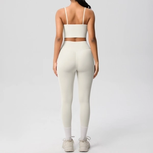 Detail of high-waist yoga leggings and sports bra set in cream white brushed fabric