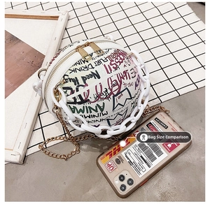 Detail of white basketball crossbody bag with colorful graffiti and gold chains