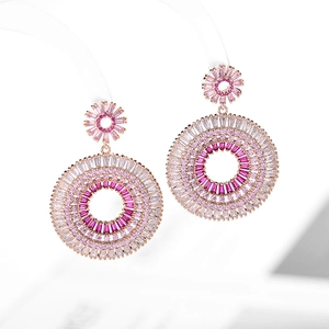 Detail of rose gold hoop earrings featuring gradient pink and white zircon crystals