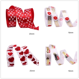 Detailed view of 16mm and 25mm Valentine ribbons with red hearts and XOXO prints
