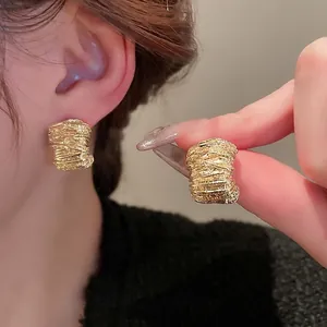 Textured gold metallic hoop earrings with wrapped detail for a minimalist elegant style