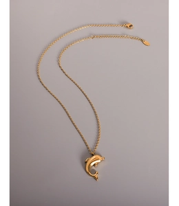 Detailed view of the 18k gold dolphin pendant with lobster clasp and extension chain