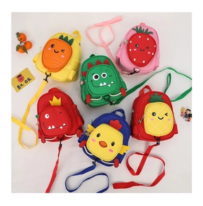 Flat lay of colorful children's canvas bags with carrot, strawberry and dinosaur designs