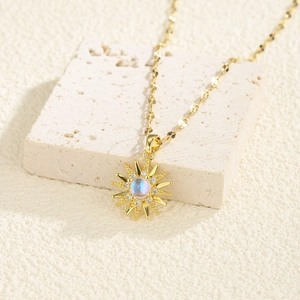 Elegant gold sun pendant necklace with moonstone and pavé diamonds on stone