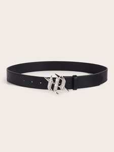 Detail of black leather belt with a vintage silver buckle set with sparkling rhinestones