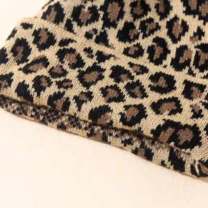 Macro shot showing the detailed knit texture and leopard pattern of the warm winter hat
