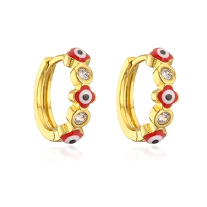 Macro detail of 18K gold plated hoop earrings with red evil eye and clear zircon stones