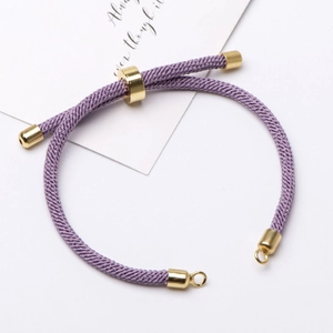 Detail of adjustable purple Milan cord bracelet with 18K gold plated metal slider bead