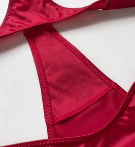 Close-up of red mesh fabric and satin trim detailing on sexy fitness thong underwear