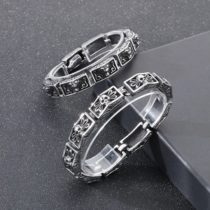 Macro view of vintage silver steel bracelet showing skull and lion head relief details