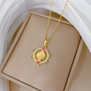 Elegant gold titanium necklace with cat-eye stone pendant and colorful crystals